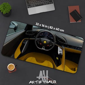 May include: A rectangular mousepad featuring a car interior with yellow seats and a black dashboard. The mousepad measures 32 x 16 inches. The text "ARTIFYHAUS" is at the bottom.