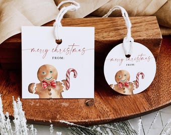 May include: White Christmas gift tags, one square and one round, with a gingerbread man illustration holding a candy cane. The tags read "merry christmas" in a cursive font, with space for a "from:" inscription. Each tag is attached with a white string.