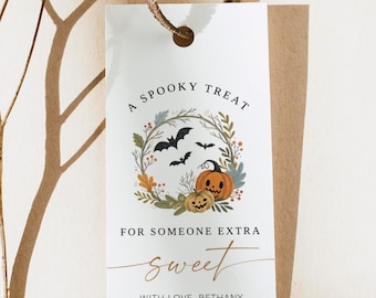 May include: White Halloween gift tag with a decorative wreath of leaves, bats, and pumpkins. The text reads "A Spooky Treat For Someone Extra Sweet With Love, Bethany."