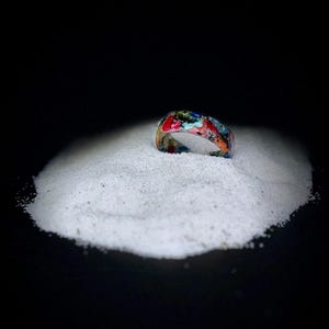 May include: A white ceramic mug with a black handle and the text "But First, Coffee" in a black, bold font. The mug is likely 11 ounces in size and sits on a white surface.