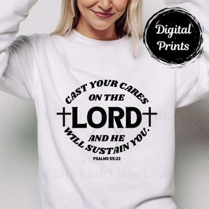May include: White sweatshirt with a black circular graphic that reads "Digital Prints." Below, a circular design with the text "Cast your cares on the Lord and He will sustain you." The text includes a cross and the Bible verse Psalms 55:22.