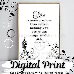 May include: A framed digital print with the quote "She is more precious than rubies; nothing you desire can compare with her." The text is in black on a white background, with floral accents. The words "Digital Print" are at the bottom.