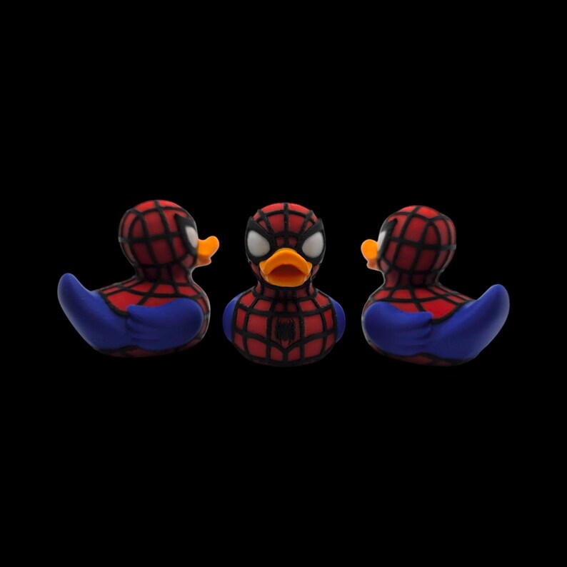 以下が含まれることがあります： スパイダーマンに似せてデザインされた3つのラバーダック。アヒルの頭と背中には赤と黒のクモの巣模様、青い翼、オレンジ色のくちばしがあります。スパイダーマンのロゴは、中央のアヒルの胸に表示されています。