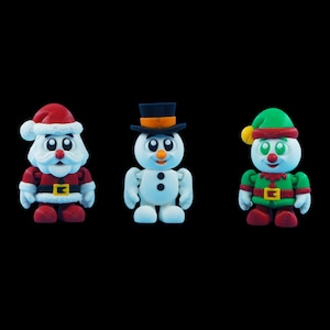 May include: Three Christmas-themed figurines: Santa Claus, a snowman, and an elf. Santa wears a red suit and hat with a white beard. The snowman has a black hat and coal buttons. The elf is in a green outfit with a red and yellow hat.