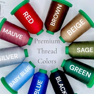 May include: A collection of spools of premium thread in various colors, including red, brown, beige, mauve, silver, baby blue, blue, black, sage, and green. Each spool has a green cap and is labeled with its color name. The text "Premium Thread Colors" is also visible.