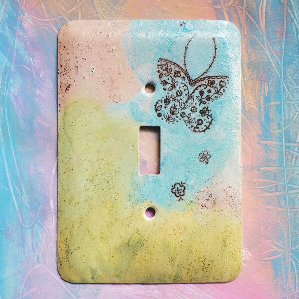 Butterfly in the Meadow, light switch cover, mixed media, collage, one of a kind, blue, green, pink, single toggle switch, metal cover