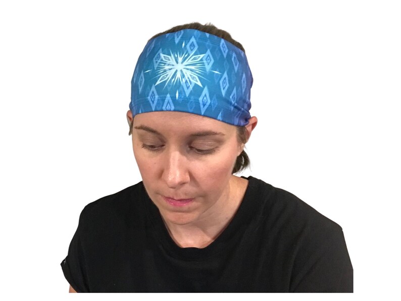 May include: A blue headband with a white snowflake design. The headband is made of a soft, stretchy material and is perfect for keeping hair out of your face.