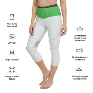 May include: White and green capri leggings with a high waistband, double-layered waistband, and a triangle-shaped gusset crotch. The leggings have a tear-away care label, UPF 50+ sun protection, and 4-way stretch fabric.