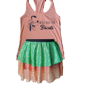 May include: A peach-colored tank top with a cartoon dog and the text "Will Run For Biscuits". The tank top is paired with a green and peach sequined skirt.