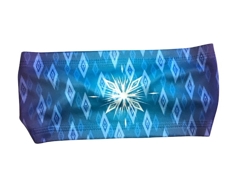 May include: A blue and purple headband with a white snowflake pattern. The headband is made of a soft, stretchy material and is perfect for keeping hair out of your face.