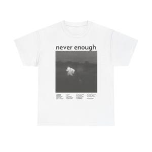 May include: White t-shirt with a black and white photo of a person in a field. The text "never enough" is printed above the photo. The tracklist for the album "Never Enough" is printed below the photo.
