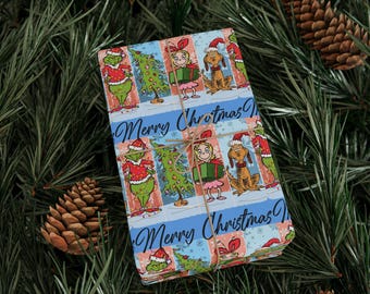 May include: Christmas-themed wrapping paper featuring cartoon characters in a festive design. The paper has a blue background with the words "Merry Christmas" and images of the Grinch, Cindy Lou Who, Max, and a Christmas tree. The paper is tied with twine.