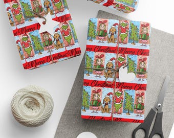 May include: Christmas-themed gift wrap featuring cartoon characters and the text "Merry Christmas." The red and blue patterned paper is wrapped around gifts and tied with twine. Accessories include scissors, tags, and twine.