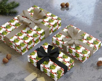 May include: Three wrapped gifts with a repeating pattern of a green character wearing a Santa hat on white wrapping paper. The gifts are tied with brown and black ribbons and bows. The gifts are on a gray surface.