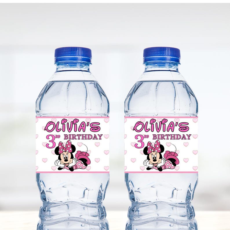 May include: Two clear plastic water bottles with pink and white labels. The labels feature a cartoon image of Minnie Mouse and the text "Olivia's 3rd Birthday".