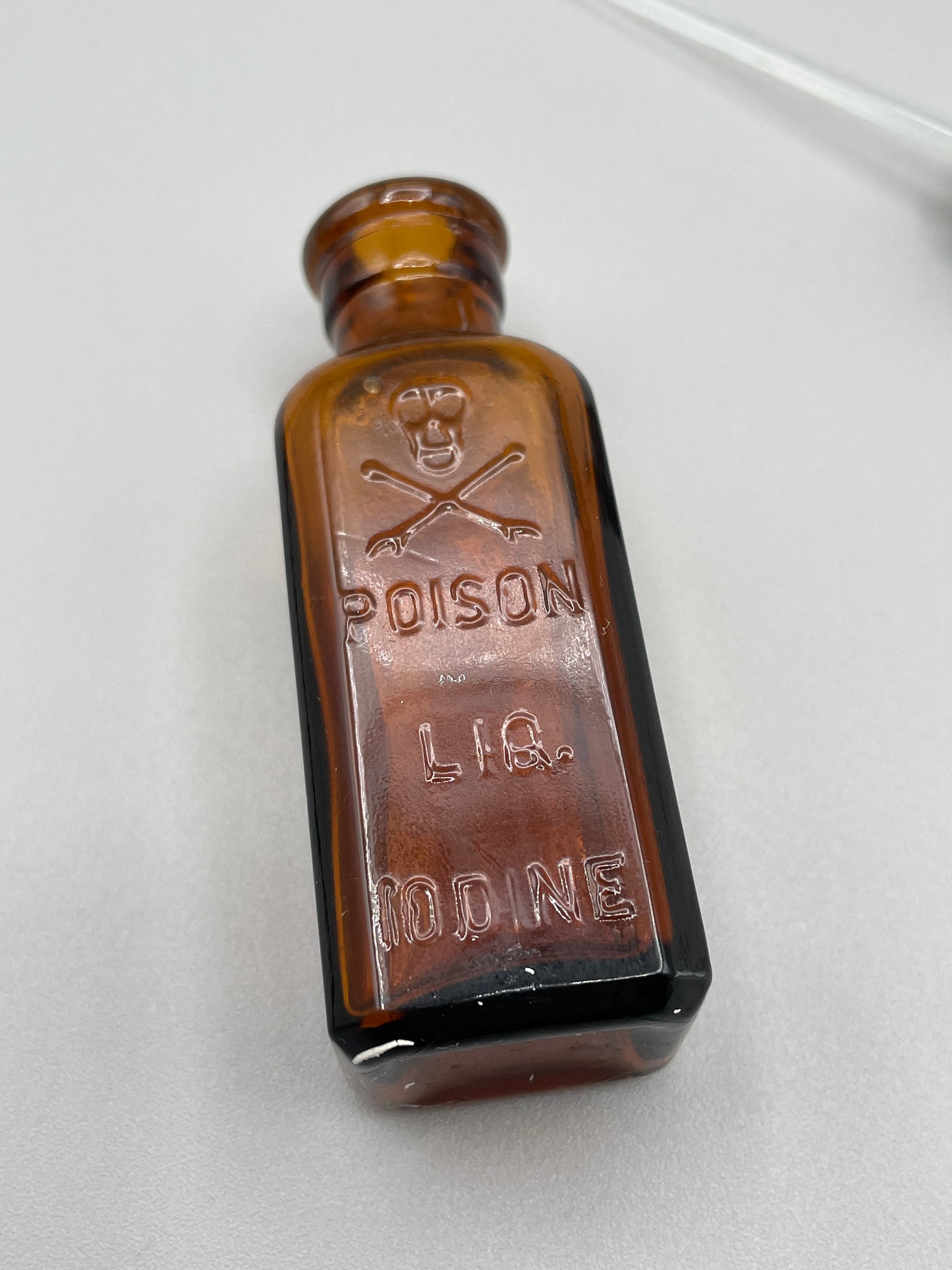 Antique Iodine Skull and Crossbones poison bottle amber glass with original rubber stopper, glass applicator and paper label