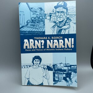 May include: A blue book cover with the title "Arn? Narn!" and the subtitle "Faces and Voices of Atlantic Inshore Fishers". The cover features illustrations of two people, one wearing a hat and the other holding a fishing pole.
