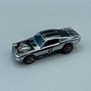 Vintage 1969 Mattel Hot Wheels Redline Mustang Boss Hoss car Silver with black stripes and blue tinted windows made in Hong Kong