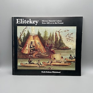May include: A book titled "Elitekey" with the subtitle "Micmac Material Culture from 1600 AD to the Present." The cover shows a painting of a Native American village scene with canoes, a teepee, and figures near a body of water.