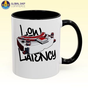 May include: White ceramic mug with a black interior and handle. The mug features a graphic of a white and red device with the words "Low Latency" in black, perfect for gamers and tech enthusiasts.