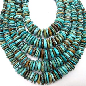 May include: A multi-strand necklace composed of numerous flat, disc-shaped turquoise beads. The beads feature a natural variation of colors, ranging from bright sky blue to deep teal and earthy brown matrix patterns, arranged in a layered design.