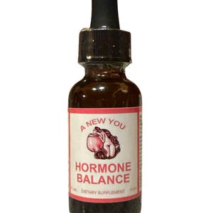 May include: A brown glass bottle with a black dropper. The label reads "A New You Hormone Balance" with a graphic of a woman and a pink vessel. The bottle is a dietary supplement, 1 fl oz.