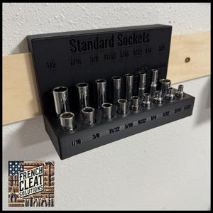 May include: A black plastic socket organizer with the text "Standard Sockets" and various sizes of sockets in rows. The organizer has the text "French Cleat Solutions" on the bottom.