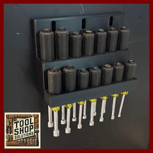 May include: A black tool organizer holding a set of Klein Tools nut drivers. The nut drivers have black handles with colored tops and silver shafts. The organizer is mounted on a dark surface. The Tool Shop Solutions logo is in the lower left corner.