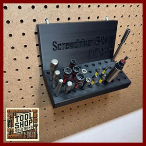 May include: Black plastic screwdriver bit organizer with the words "Screwdriver Bits" embossed on the front. The organizer holds various screwdriver bits and a screwdriver. The Tool Shop Solutions logo is in the lower left corner.