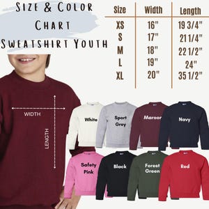 May include: A youth sweatshirt size and colour chart. The chart displays sizes XS to XL with corresponding width and length measurements in inches. The image shows sweatshirts in white, sport grey, maroon, navy, safety pink, black, forest green, and red.