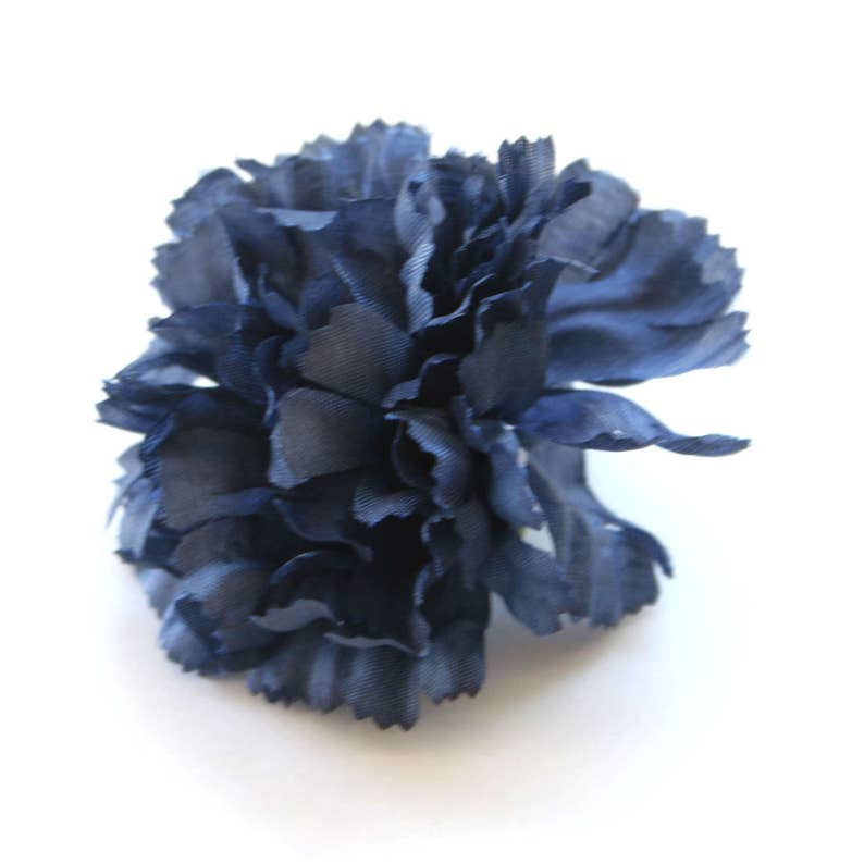 May include: A single navy blue carnation flower. The flower is made of fabric and has a ruffled texture.