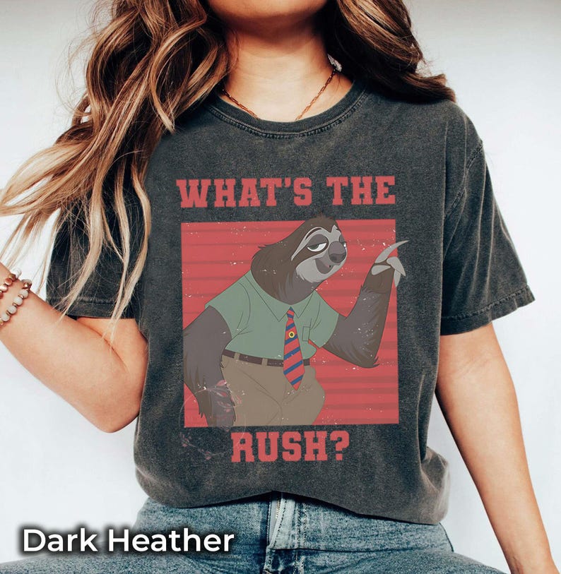 May include: Dark heather gray t-shirt featuring a cartoon sloth in a green shirt and tie, with the text "WHAT'S THE RUSH?" in red. The shirt has a vintage, worn look.