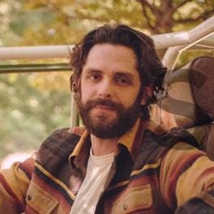 May include: A white ticket with black text for a live music event featuring Thomas Rhett. The ticket has fields for date, time, and state. The ticket number is 0123456789.