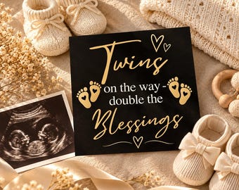 May include: A black square sign with gold text reading Twins on the way - double the Blessings, featuring gold baby footprints and hearts. It is surrounded by two pairs of cream-colored knit baby booties, a sonogram, and a knit blanket.