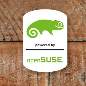 May include: A white ceramic mug with a black handle and the text "But First, Coffee" in a black, bold font. The mug is sitting on a wooden surface. The mug is approximately 4 inches tall.