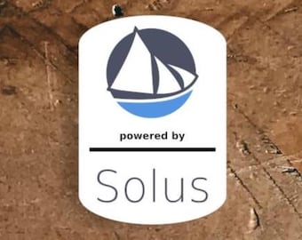 May include: A white, blue, and navy logo with a sailboat design, set against a brown background. The text "powered by" is above a horizontal line, with the name "Solus" below in a sans-serif font.