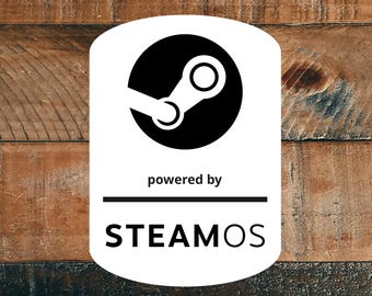 May include: A white rectangular sticker with rounded corners featuring the black Steam logo at the top, followed by the text "powered by" and a horizontal line, with the word "STEAMOS" printed in bold black capital letters at the bottom.