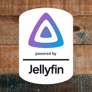May include: A white rectangular sign with rounded corners featuring a purple to blue gradient triangular logo at the top. Below the logo, the text reads "powered by" in black, followed by a horizontal line and the word "Jellyfin" in black.
