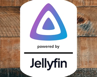 May include: A white rectangular sign with rounded corners featuring a purple to blue gradient triangular logo at the top. Below the logo, the text reads "powered by" in black, followed by a horizontal line and the word "Jellyfin" in black.