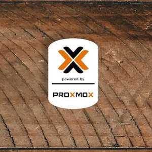 May include: A white rectangular logo with the text "powered by" above the word "PROXMOX". The logo features a black and orange X-shaped design. The background is a wooden surface.