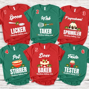 May include: Six short-sleeved t-shirts in red and green with Christmas baking crew designs. The shirts feature text like "Spoon Licker", "Whisk Taker", "Professional Sprinkler", "Pot Stirrer", "Boss Baker", and "Taste Tester".