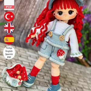 May include: A handmade crochet doll with red hair, blue hat, and denim dungarees. The doll has a mushroom motif on the shorts and carries a mushroom-shaped purse. The image text reads "PDF Pattern Only - Not Finished Doll."