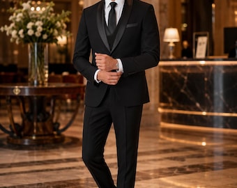 May include: A black tuxedo suit featuring a single-button jacket with satin shawl lapels, a matching black waistcoat, a crisp white dress shirt, and a black necktie. The ensemble includes tailored black trousers and polished black dress shoes.