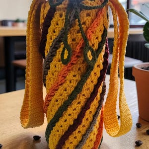 May include: A white ceramic mug with a black handle and the text "But First, Coffee" in a black, bold font. The mug is sitting on a white surface. The mug appears to be 12 ounces.