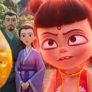 May include: A cartoon image of a young girl with red skin and a red and gold outfit. She has a serious expression on her face and her eyes are wide open. She is surrounded by other cartoon characters.