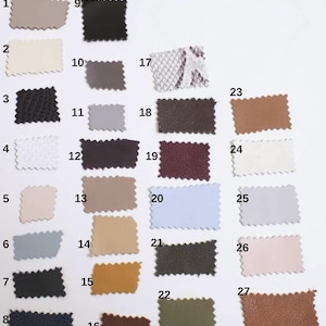 May include: A collection of 27 fabric swatches in various colors and textures. The swatches include shades of beige, black, white, gray, blue, brown, and patterned options. Each swatch has a zig-zag edge.
