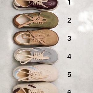 May include: Six pairs of sneakers in different colors and styles. The sneakers are arranged vertically from top to bottom, with the numbers 1 through 6 next to each pair. The sneakers are all low-top and have laces.