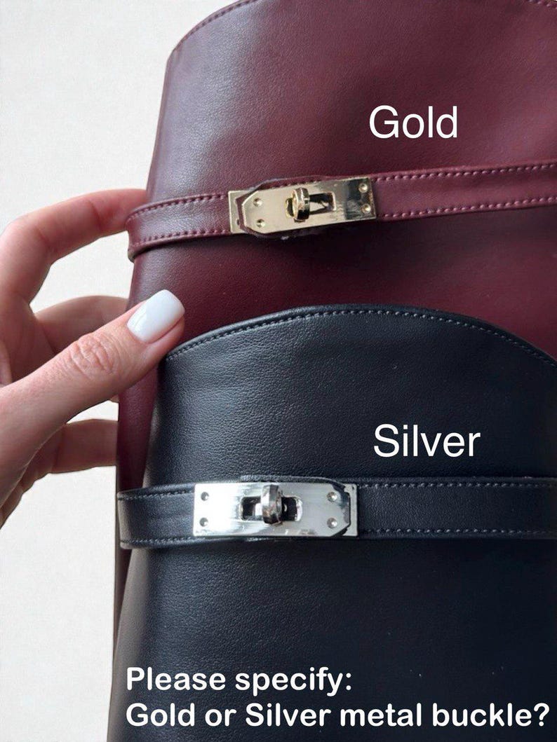 May include: A burgundy leather item with a gold metal buckle and a black leather item with a silver metal buckle. The text Gold, Silver, and Please specify: Gold or Silver metal buckle? are visible on the image, indicating hardware options.