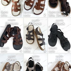 May include: A collection of suede sandals in various colors, including auburn, brown, taupe, black, and grey. Each pair features a strap design with buckles and a light or black sole. The sandals are displayed on a white surface.