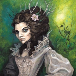 May include: A woman with a crown of antlers and a pink flower in her hair wears a white dress with lace trim. She stands in a woodland setting with green foliage and a thorny branch in the foreground.